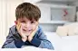 Cute boy lying on bed