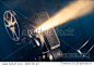 film projector on a wooden background with dramatic lighting and selective focus
