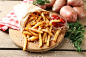 Tasty french fries on cutting board, on wooden table background :: Stock Photography Agency :: Pixel-Shot Studio