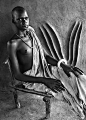 Africa | Dinka Girl. Dinka in a traditional house, representation of horns is carved into the wall. Village of Ger. Southern Sudan |  © Sebastião Salgado, 2006