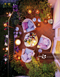Balcony with lit candles, patio, cushions and flowers, overhead view
