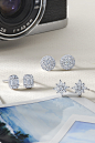 This may contain: three pairs of diamond stud earrings next to a camera