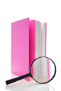 Royalty-free Image: Magnifying glass next to book with pink cover