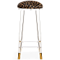 Helsinki Bar Stool in Cowhide : The Helsinki Bar Stool is an unassuming beauty. Featuring a solid lucite body and brass capped legs, the Helsinki Bar Stool is a stylish new take on the classic barstool. Its clear body reflects its surroundings and changes