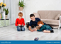 boys-sit-floor-room-play-machine-remote-control-two-little-older-brather-nanny-teenager-150581111.jpg (1600×1158)