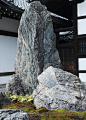 A rock arrangement on a bed of moss stands by the entrance to the 14th century Zen garden at Tenryu-ji Temple, Kyoto