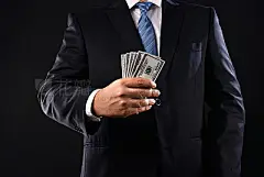 Businessman showing a stuck of money