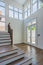 Example of a large transitional light wood floor entryway design in Dallas with white walls and a white front door