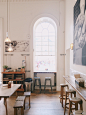 Two Grey Wooden Stools Near Window With Arc Frame