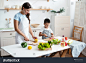 stock-photo-young-mother-with-her-son-are-cooking-together-healthy-vegetable-salad-cutting-tomatoes-and-other-2018848547