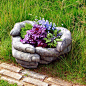 Unusual Garden Containers(hands from http://www.gardenornamentsdirect.com/hands-cupped-garden-planter.html): 