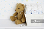 Teddy bear beside cloth diapers