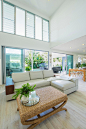 Example of a mid-sized trendy open concept porcelain tile living room design in Brisbane with white walls and a wall-mounted tv