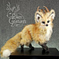 This may contain: a small stuffed animal on top of a wooden table next to a gray wall with the words rider creatures written above it