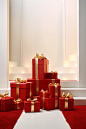 In this illustration, red boxes with ribbon on top of them, in the style of large-scale photography, elegant compositions, carpetpunk, xmaspunk, minimalist still lifes, light white and gold, lively interiors