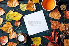 一张白纸，一张白方卡片，一杯茶，一支蜡烛，秋叶。文具模型与文字的地方，在头顶平铺拍摄