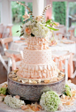 peach wedding cake in ruffled fabric textures