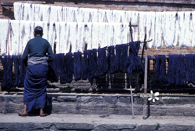 Man hanging dyed tex...