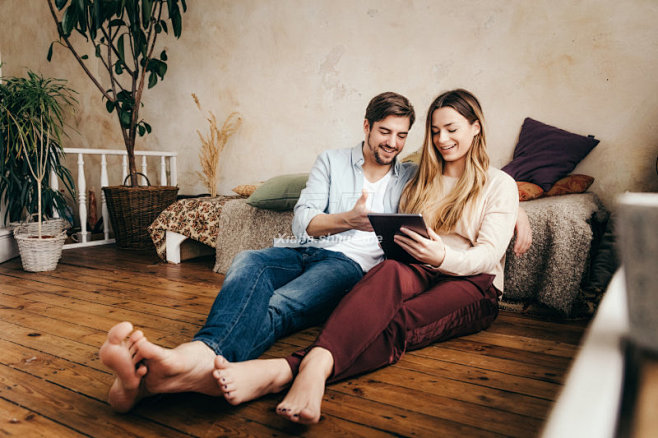 Couple using digital...