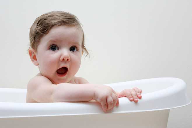 Happy baby taking ba...