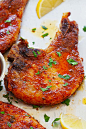 Oven baked pork chops with bone-in pork chops, butter, dry rub and thyme.