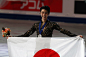 Silver medallist Yuzuru Hanyu of Japan poses with a Japanese national flag after a victory ceremony for the mens singles competition at the 2019 ISU...