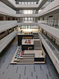 This may contain: the interior of an office building with multiple floors and balconies on each floor