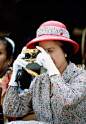 Queen Elizabeth II takes a picture with her camera while visiting Tuvalu in the South Pacific in 1982