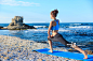 Young woman stretching on beach_创意图片