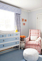 Blue nursery features white and pink glider with white elephant table (Serena and Lily ) and white Moroccan leather pouf // blue nursery room