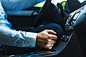 Close-up of man's hand shifting gear in car