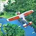 This may contain: an airplane flying over a lush green forest filled with trees and clouds in the sky