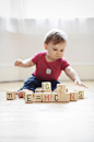 Baby boy playing with toy blocks arranged to read "E=mc2" by photoalto on 500px