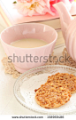 Caramel cookie and milk tea with book on background - stock photo