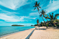 Beautiful tropical beach sea and sand with coconut palm tree on blue sky and white cloud Free Photo