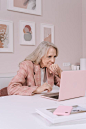 Woman in Pink Sweater Sitting on Bed