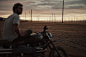 Triumph : A man, a motorcycle and an empty field under the California sun. 