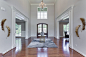 Example of a classic dark wood floor and brown floor entryway design in DC Metro with gray walls and a dark wood front door