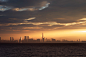 a large body of water with a city in the background