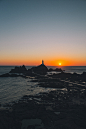 man standing on rock formation during golden hour