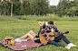boy-playing-guitar-his-girlfriend-picnic-blanket