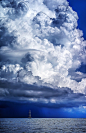 Sailboat under a magnificent cumulonimbus, at the mediterranean, near the Praiano, Italy. Salerno Campania