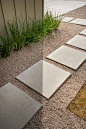 Concrete pavers in a gravel path lead the way to the front door. Drought-tolerant grasses line the landscape and are easy to maintain. It's black-thumbs approved! --> http://www.hgtv.com/design/hgtv-smart-home/2015/front-yard-pictures-from-hgtv-smart-h