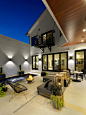 Inspiration for a contemporary backyard concrete patio fountain remodel in St Louis with a roof extension