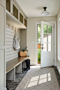 Example of a mid-sized transitional porcelain tile mudroom design in Minneapolis with beige walls