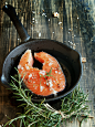 raw salmon steak on  cast-iron pan with rosemary and spices,  wooden table, selective focus by Viktoria Ag on 500px