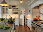 White Kitchen Ideas. This white kitchen has so many great design ideas. Countertop is honed Pietra De Cardosa and the perimeter counters are Blizzard Caesar Stone. The stunning pendants are the Orson Pendants by Remains. Cabinet Paint Color: "Benjami