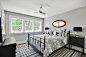 Example of a small beach style guest dark wood floor and brown floor bedroom design in Minneapolis with gray walls and no fireplace