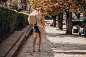 Woman holding big parcel box and walking in the street