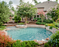 This is an example of a large classic back round swimming pool in Houston with brick paving. — Houzz